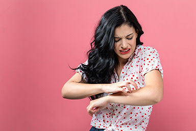 Woman scratching her arm